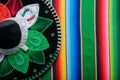 Mariachi hat with the colors of the Mexican flag on a colorful serape