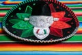 Mariachi hat with the colors of the Mexican flag on a colorful serape