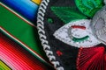 Mariachi hat with the colors of the Mexican flag on a colorful serape