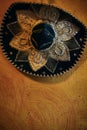 Mariachi sombrero hat with sequins on a orange wall