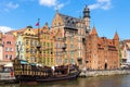 Mariacka Gate and Archeological Museum along the Hanseatic houses pier at Motlawa river embankment in old town city center in Royalty Free Stock Photo