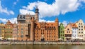 Mariacka Gate and Archeological Museum along the Hanseatic houses pier at Motlawa river embankment in old town city center in Royalty Free Stock Photo