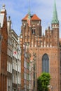 Mariacka street with colorful facades of tenement houses and St.Mary church, Gdansk, Poland Royalty Free Stock Photo
