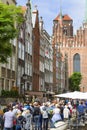 Mariacka street with colorful facades of tenement houses and St.Mary`s Church, Gdansk, Poland Royalty Free Stock Photo