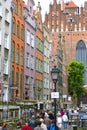 Mariacka street with colorful facades of tenement houses and 16th century gothic St. Mary`s Church, Gdansk, Poland Royalty Free Stock Photo