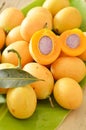 Marian plum tropical fruit produced in summer half cut on banana leaf Royalty Free Stock Photo