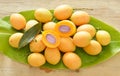 Marian plum tropical fruit produced in summer half cut on banana leaf Royalty Free Stock Photo
