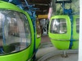 Climbing a mountain in a green cable car cabin in the mountains on a sunny summer day. Czech Republic. Europe.