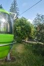 Climbing a mountain in a green cable car cabin in the mountains on a sunny summer day. Czech Republic. Europe.