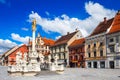 Maribor/Slovenia - July 20, 2020: Main square, buildings and plague column in Maribor city, Slovenia. Defocused Royalty Free Stock Photo