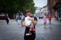 Selective blur on a young man, a waiter, worker, hands full of bottles of coca cola, overloaded, trying to carry them. Royalty Free Stock Photo