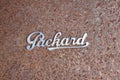 Old Packard logo on a rusty fender