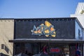 The Marietta Pizza Company with a red neon open sign and blue sky in Marietta Georgia