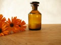 Marigold flowers and homeopathic pills in bottle Royalty Free Stock Photo
