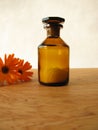 Marigold flowers and homeopathic pills in bottle Royalty Free Stock Photo