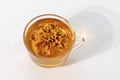 Marigold herbal tea in a glass cup and fresh flowers.Isolated on a white background Royalty Free Stock Photo