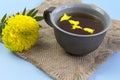 Marigold herbal tea in a glass cup fresh flowers on sackcloth Royalty Free Stock Photo