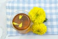 Marigold herbal tea in a glass cup fresh flowers on sackcloth Royalty Free Stock Photo