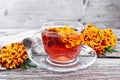 Tea herbal of marigolds in glass cup on board Royalty Free Stock Photo