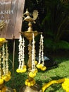 Marigold and Tuberose or Sugandaraja flower Decorated to the Brass Metal Traditional Oil Lamp at the Top Bird Shape