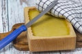 Marijuana butter with wooden mould on blue old table with checker dish towel Royalty Free Stock Photo