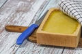 Marijuana butter with wooden mould on blue old table with checker dish towel Royalty Free Stock Photo