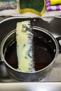 Marijuana green butter made in metallic cooking pot in kitchen Royalty Free Stock Photo