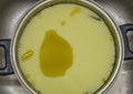 Marijuana green butter made in metallic cooking pot in kitchen Royalty Free Stock Photo
