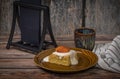 Marijuana vanilla apricot cake on brown dish and wooden table with cup