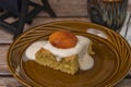 Marijuana vanilla apricot cake on brown dish and wooden table with cup