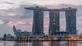 Marina Bay Sands Hotel dominates the skyline at Marina Bay in Singapore night to day timelapse. Royalty Free Stock Photo