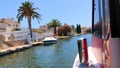 Marina boat trip from passenger\'s eyes view trough the famous canals of Empuriabrava in Catalonia, Spain on June 23 2022