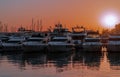 Marina with boats and yacht under sunset