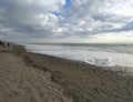 Mediterranean Sea, Marina di Bibbona, Italy. Sandy beach, storm clouds over the sea,waves with foam, panorama.