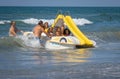 Family on a marine pedal catamaran trying to land across the waves at Marina San Nicola beach in Italy