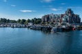 A marina at the entrance to Victoria harbour, Vancouver Island, Canada, sparkling blue waters and bright blue sky.