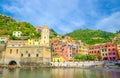 Marina harbor, Chiesa di Santa Margherita di Antiochia church, green hill and colorful buildings houses in Vernazza Royalty Free Stock Photo