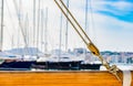 Yachting, pulley nautical ropes rigging on wooden mast