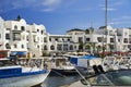 Marina of Port el Kantaoui with a view over a motor yacht in the foreground to the sophisticated holiday apartment complex in the