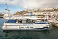 Puerto Rico, Gran Canaria - December 16, 2017: Marina of Puerto Rico, tourists entering the boat on the gangway, to