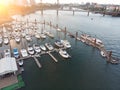 Marina on the river bank, sea with yachts, with the city aerial view from above at sunset Royalty Free Stock Photo