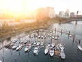 Marina on the river bank, sea with yachts, with the city aerial view from above at sunset Royalty Free Stock Photo