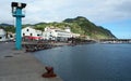 Marina and waterfront bathing pool, rusty mooring cleat on the concrete berth in the forefront, Povoacao, Sao Miguel Island, Azore