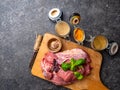 Marinade powder, spices on fresh juicy meat on Gray Background