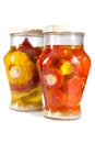 Marinaded tomatoes and bush pumpkins and vegetable in a glass jar.Still-life on a white background