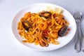 Marinara pasta with shrimps, octopus and mussels. Homemade noodles with seafood in tomato sauce. Traditional Italian dish. Royalty Free Stock Photo