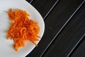Marinated carrots with spices in a white plate