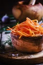 Marinated carrots in a wooden bowl, selective focus
