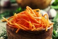 Marinated carrots in a wooden bowl, selective focus