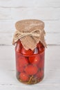 Marinated cherry tomatoes in a jar.